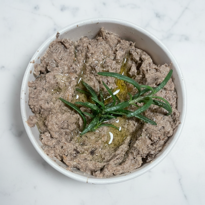 Mushroom pate with rosemary in a white bowl on a white background